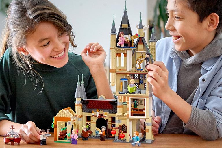 Girl and boy playing with LEGO® Harry Potter Hogwarts Astronomy Tower Playset 75969.