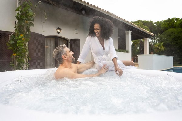 A couple enjoying each other's company and relaxing at home in a Lay-Z-Spa inflatable hot tub.
