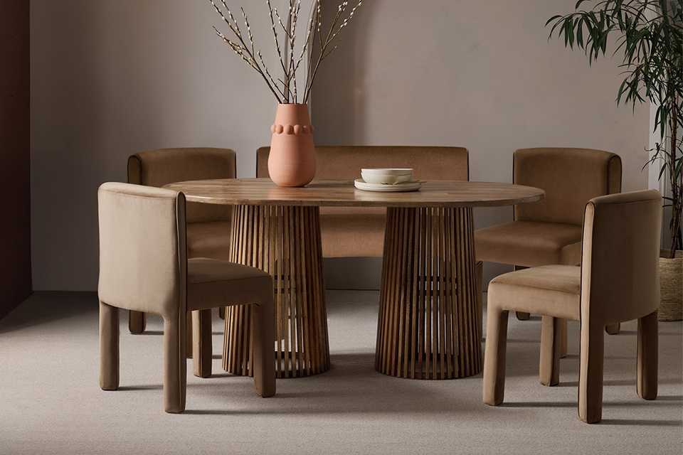 Dining table with brown velvet chairs.