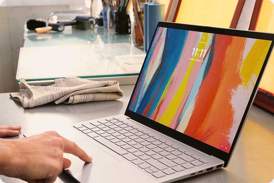 A person working on a Windows 11 PC on a desk.