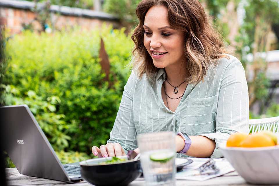 A woman shops using her laptop.