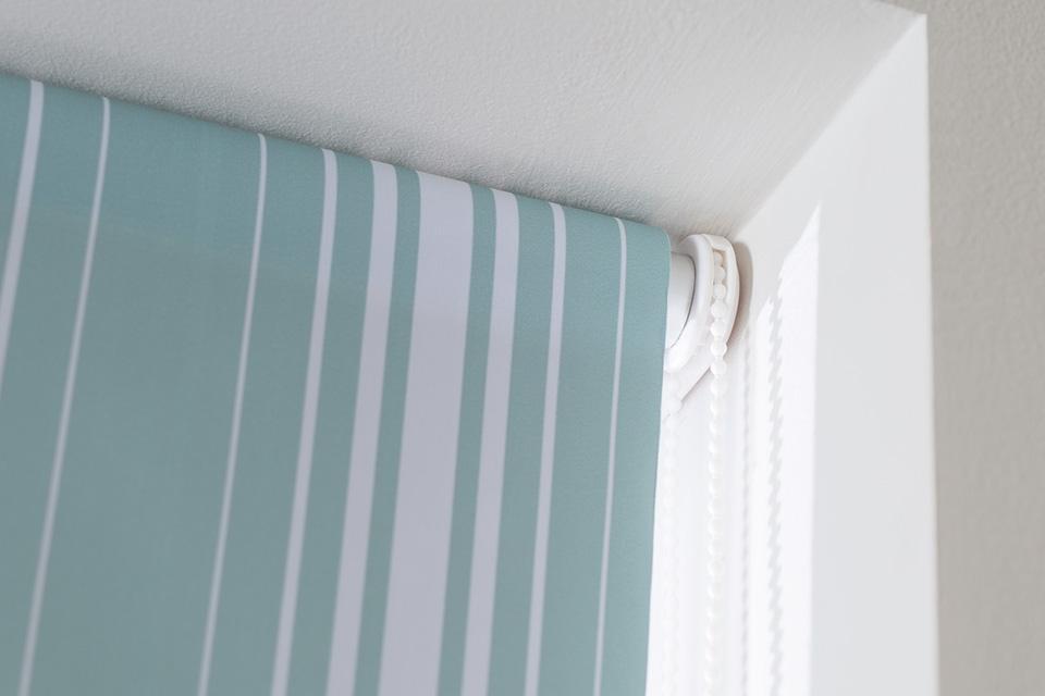 Striped turquoise roller blind.