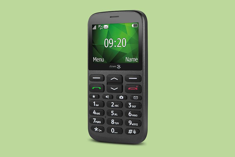 A Doro 1370 phone on a white background, slightly tilted to the side and displaying an illuminated screen.