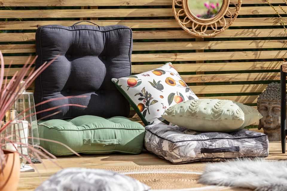 Cushions on kept on sofa set in a garden.