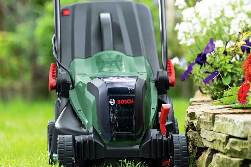 A Bosch UniversalRotak 37cm cordless rotary lawnmower placed on a lawn.