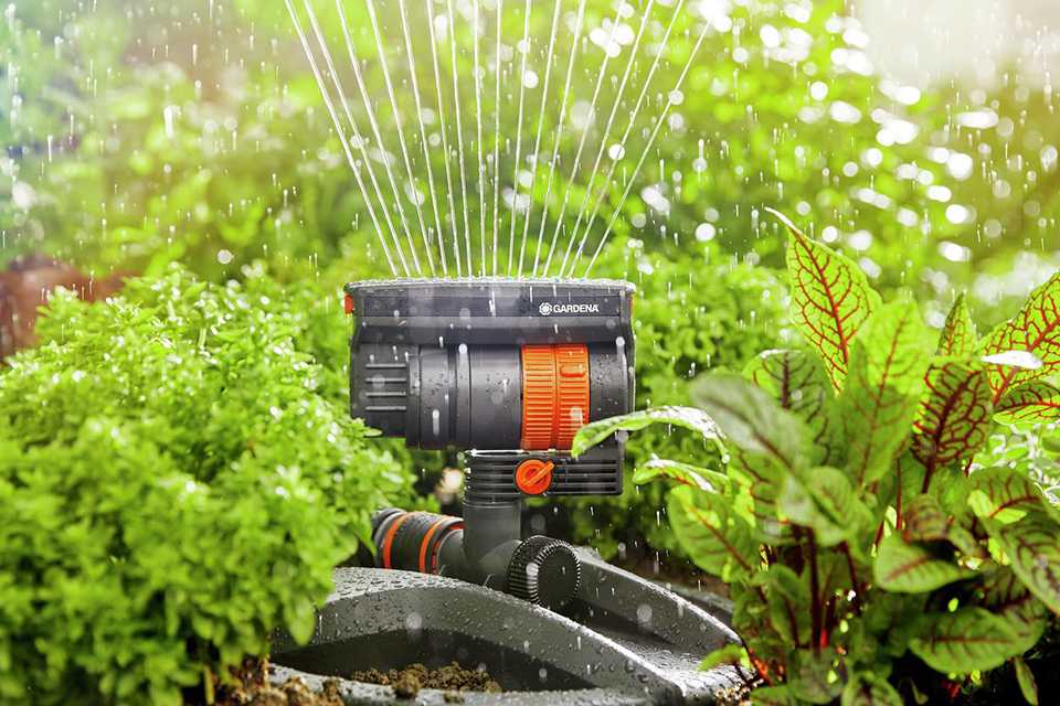 A Gardena AquaZoom compact sprinkler and waterstop being used in a lawn.
