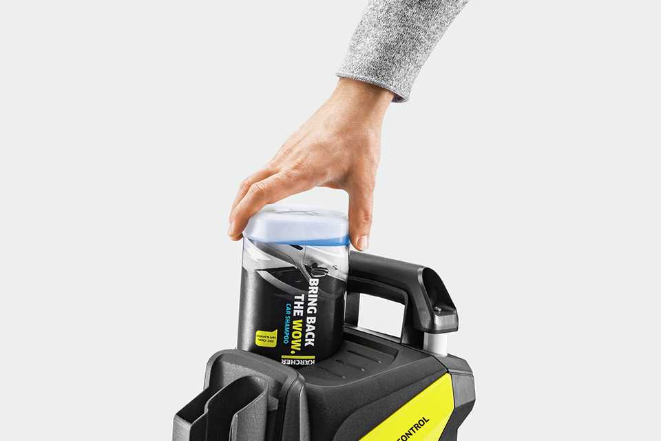 A person putting detergent in Karcher K5 Power Control Car & Home pressure washer.