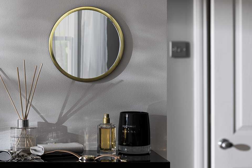 Bedroom mirror hanging on wall.
