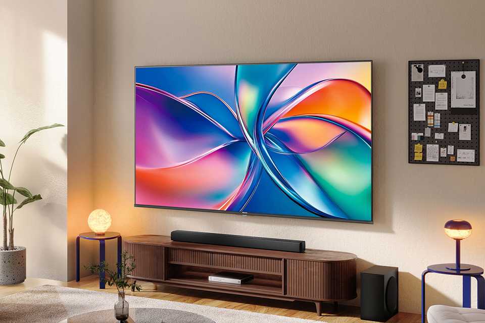 image of a TV in a lounge set filled with a tv stand and other lounge furniture