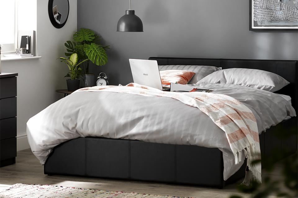 A leather upholstered bedframe.