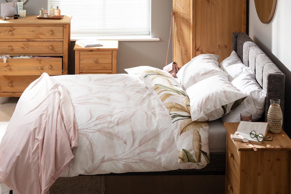 A rustic country bedroom combining a global theme and tropical bedding.