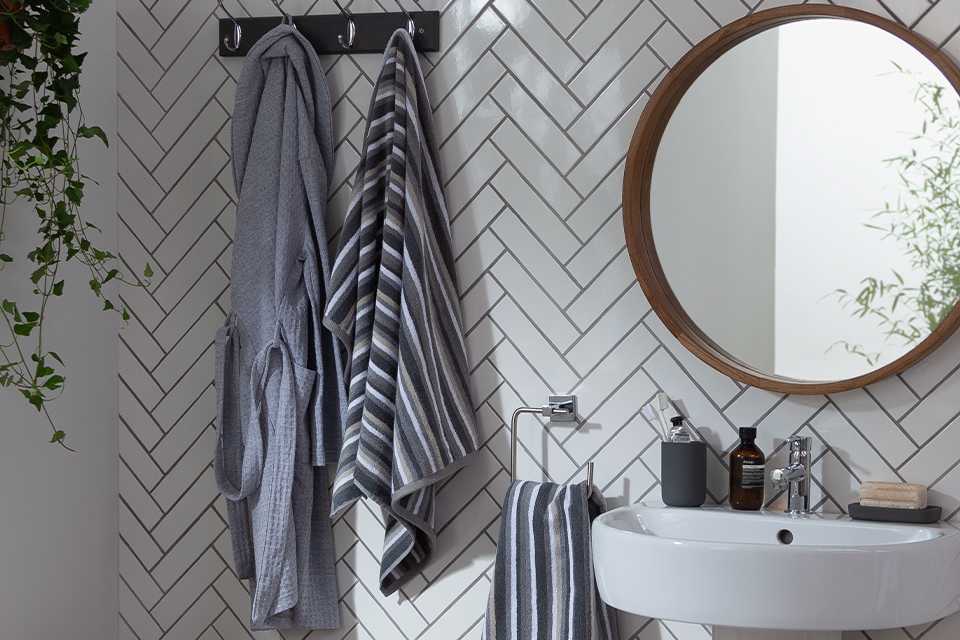 Towels in bathroom hanging on hooks.