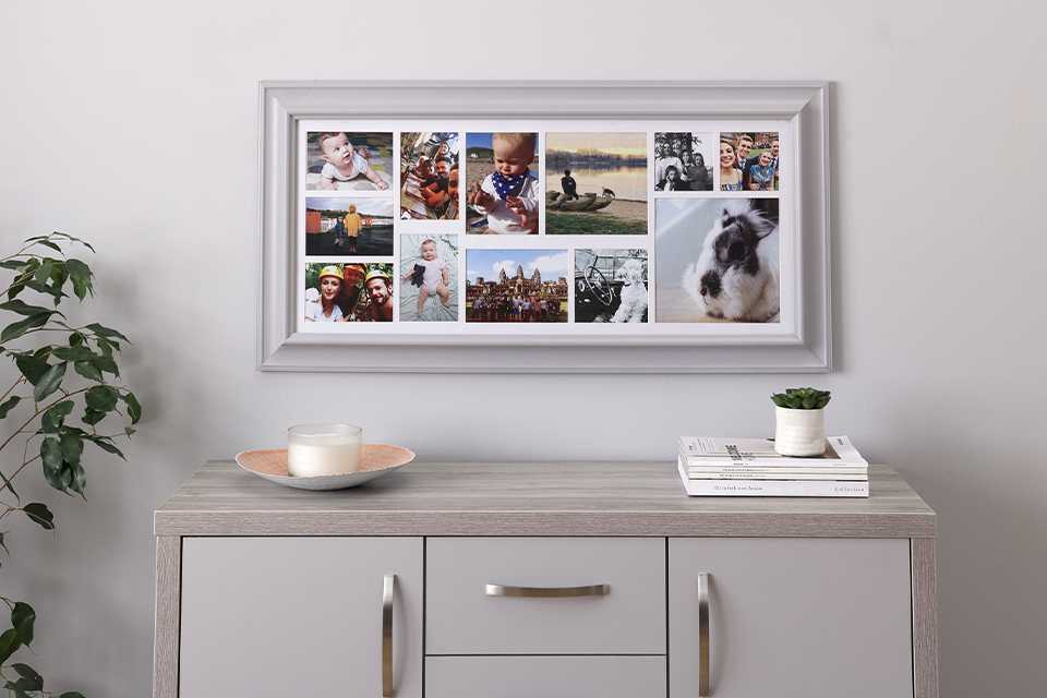 Photo collage in grey frame hanging on white wall.