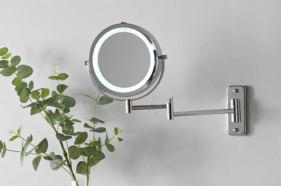 Image of a round, extendable, light-up bathroom wall light.