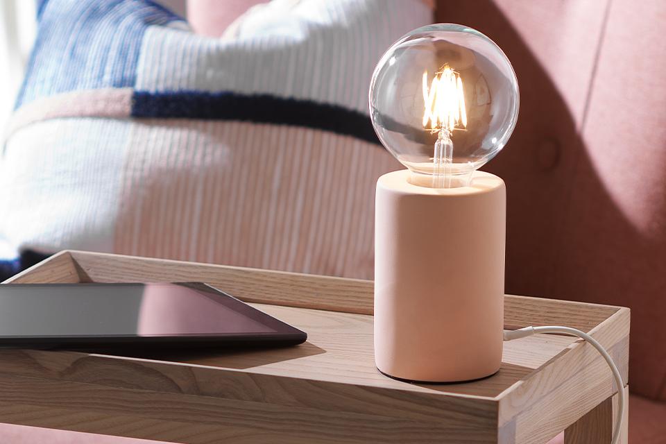 An image of a table lamp with an exposed bulb.