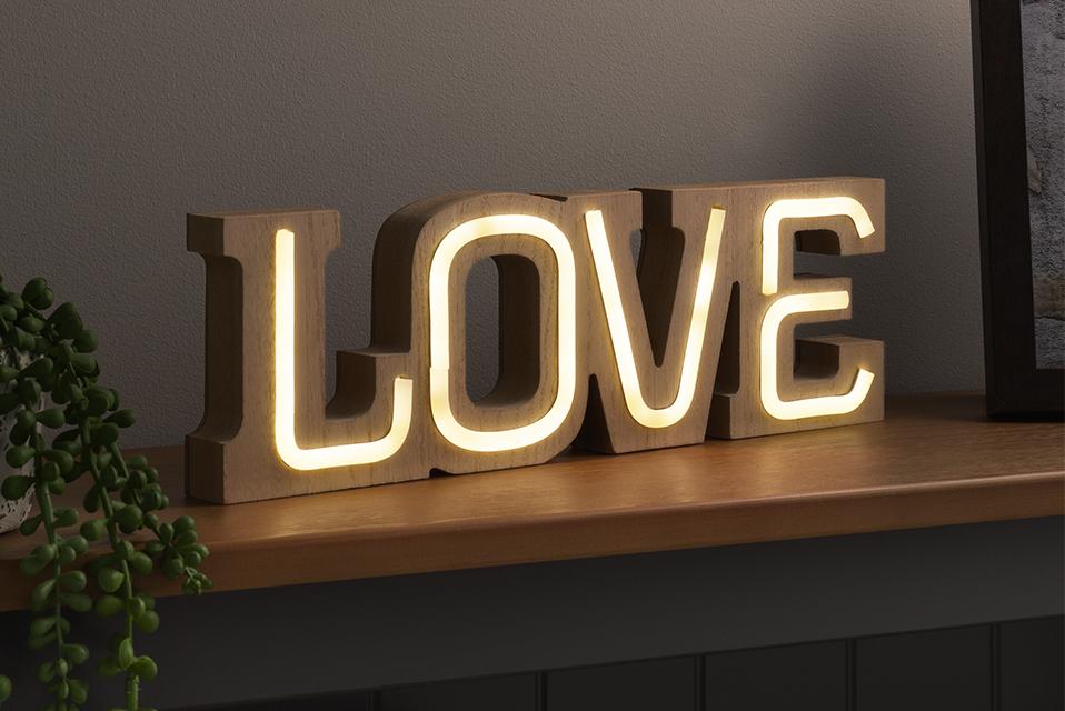 Image of a light-up sign that says 'love'.