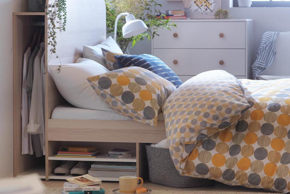 Image of a guest bedroom with a patterned pillow and duvet set.