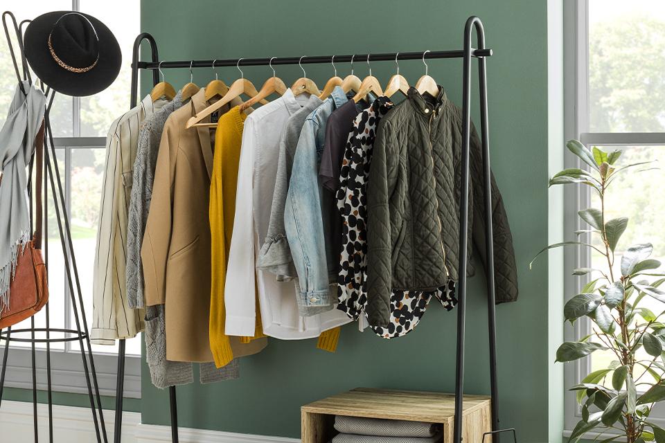Image of a clothes rail in a green room.