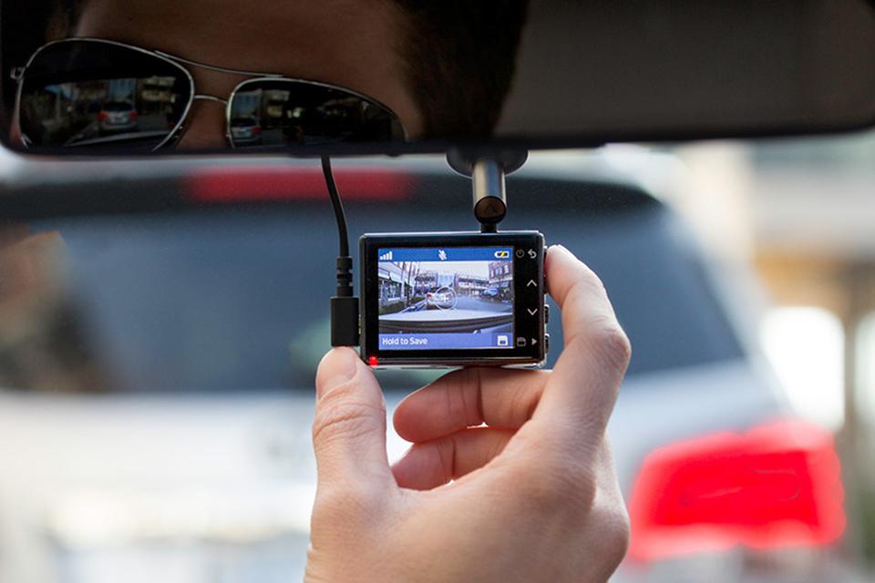 Man turning on dash cam to record.