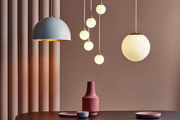 Range of ceiling lights hanging above table.