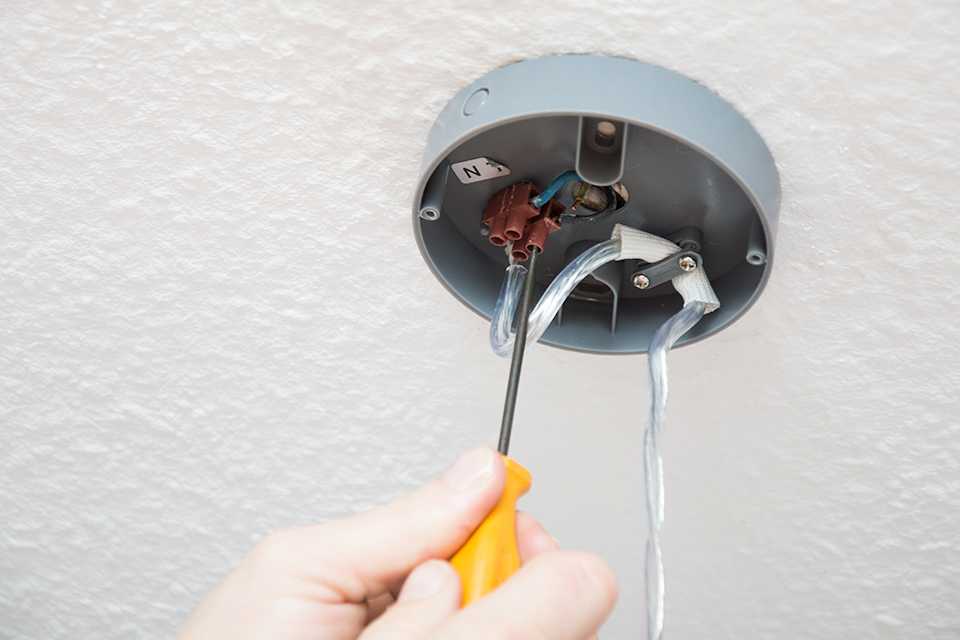 Fitting a ceiling light.