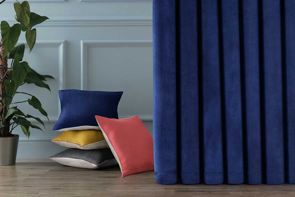 Blue velvet curtains and velvet cushions.