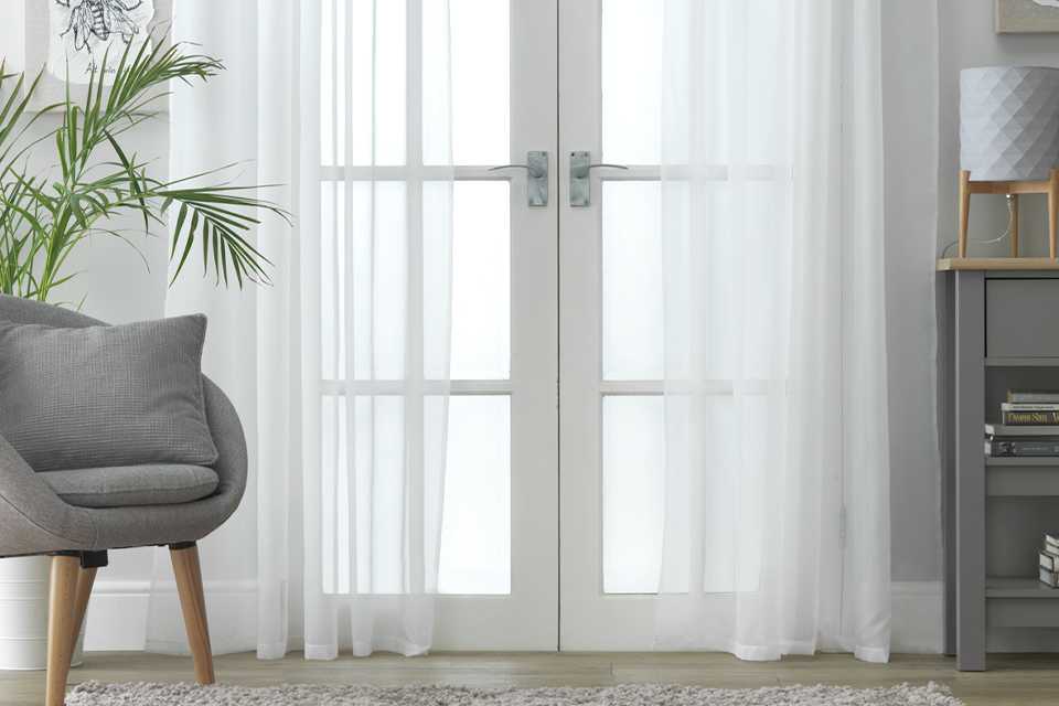 Sheer voile curtains in a living room.