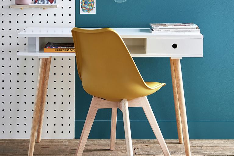 Image of a slim desk with a yellow office chair.