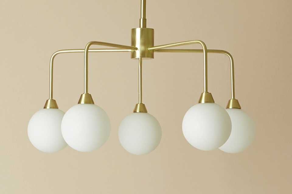 Gold flush ceiling light with sphere pendants.