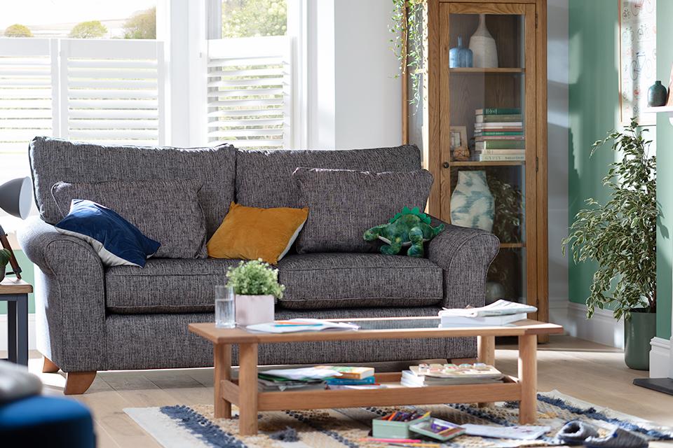 Image of grey fabric sofa next to coffee table.