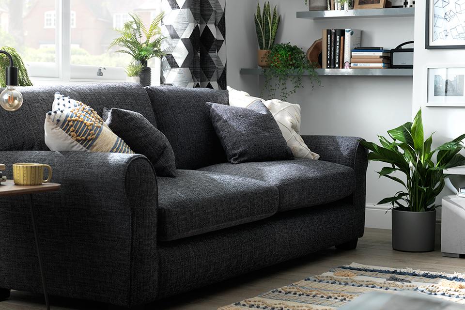 Image of grey sofa with cushions in living room.