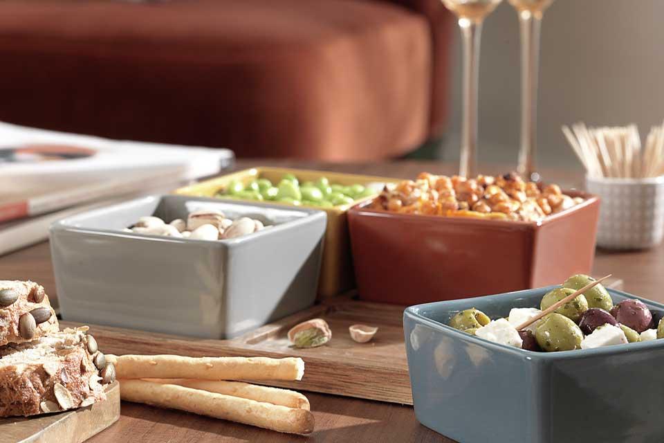 Nibbles and wine on a coffee table.