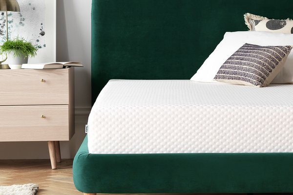 Green velvet bed with white mattress.