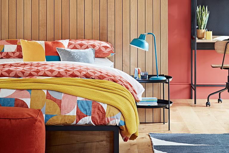 Image of a bed in a bedroom setting.