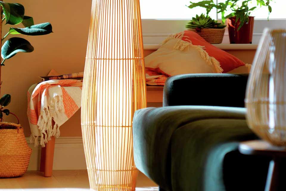 A relaxed lounge with a bamboo floor lamp and a matching table lamp.