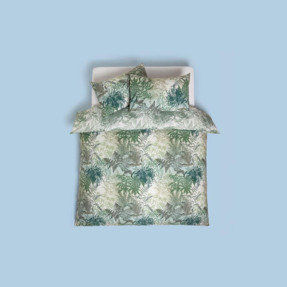 Green and white botanical leaf print bedding.