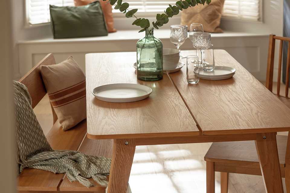 Habitat Nel oak dining table & 2 oak benches in a small dining room.