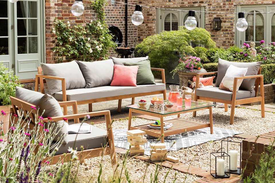 Orange sofa set sitting in a garden.
