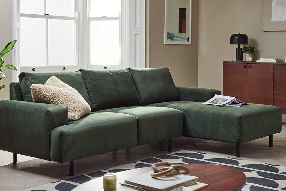 Green corner sofa in living room.