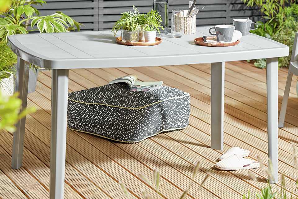 A grey Argos Home 6 Seater Rectangular Plastic Garden Table.