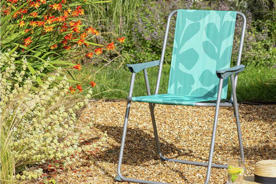 A green Habitat folding metal garden chair.
