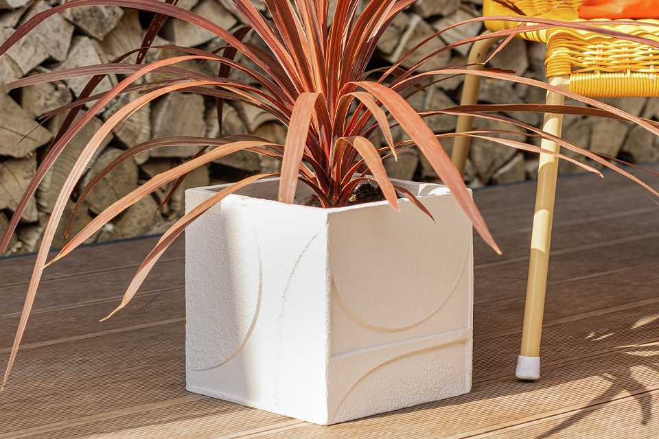 Habitat 20cm square resin planter in off-white colour with textured geometric design on it.
