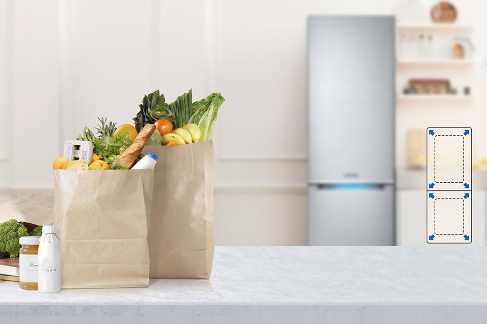 Two bags of shopping with fridge freezer in background.