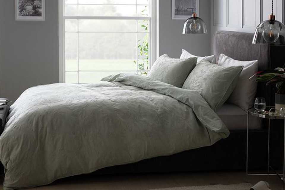 Boutique style bedroom with grey bed.