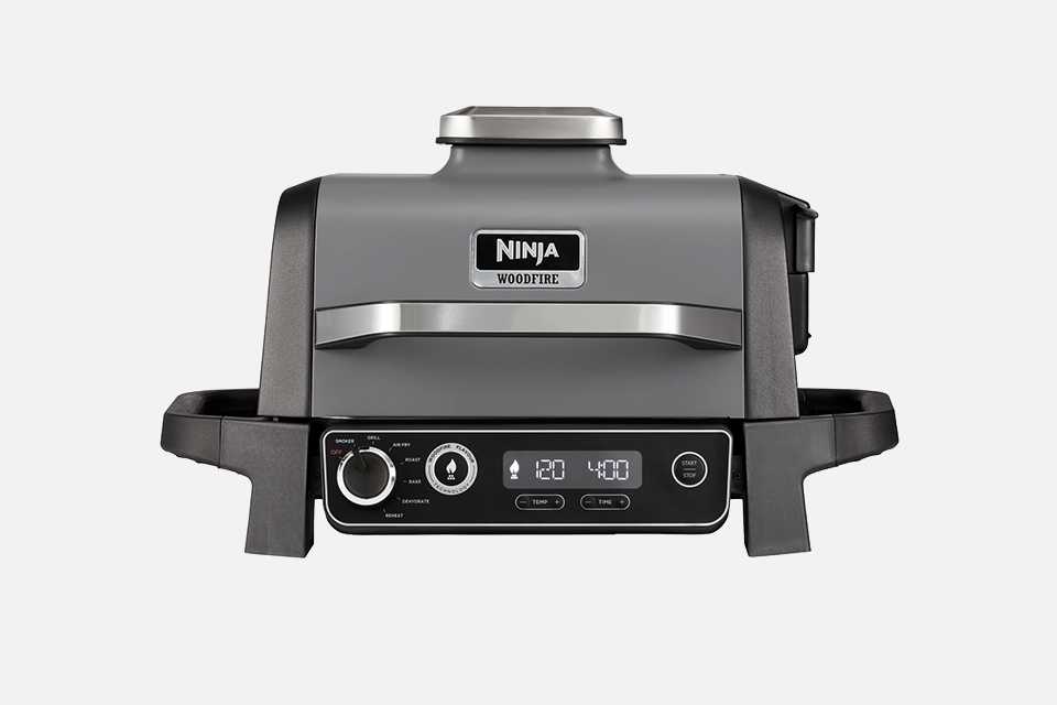 A cut out image of Ninja OG701UK Woodfire Electric BBQ Grill & Smoker.