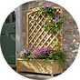 Flowers on a large lattice wooden garden planter.