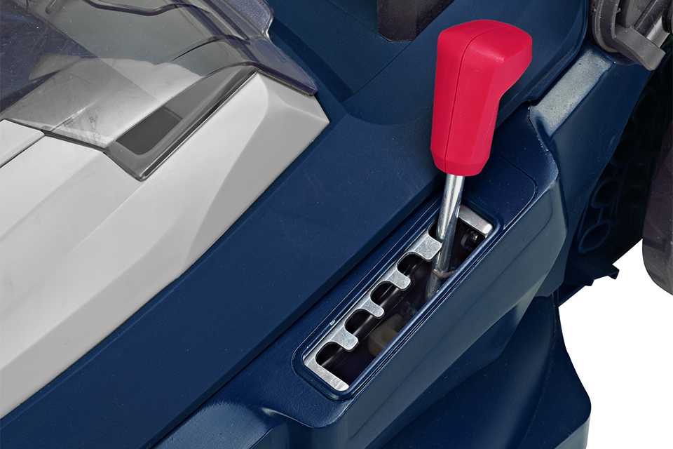 A close up image of a lawnmowers height adjustment lever.