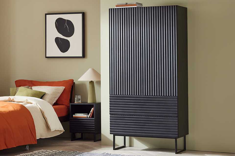 Black wardrobe in bedroom.