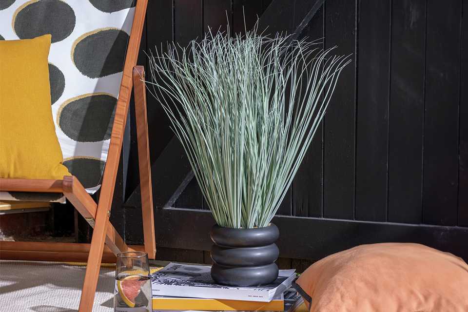 potted grass in a garden setting