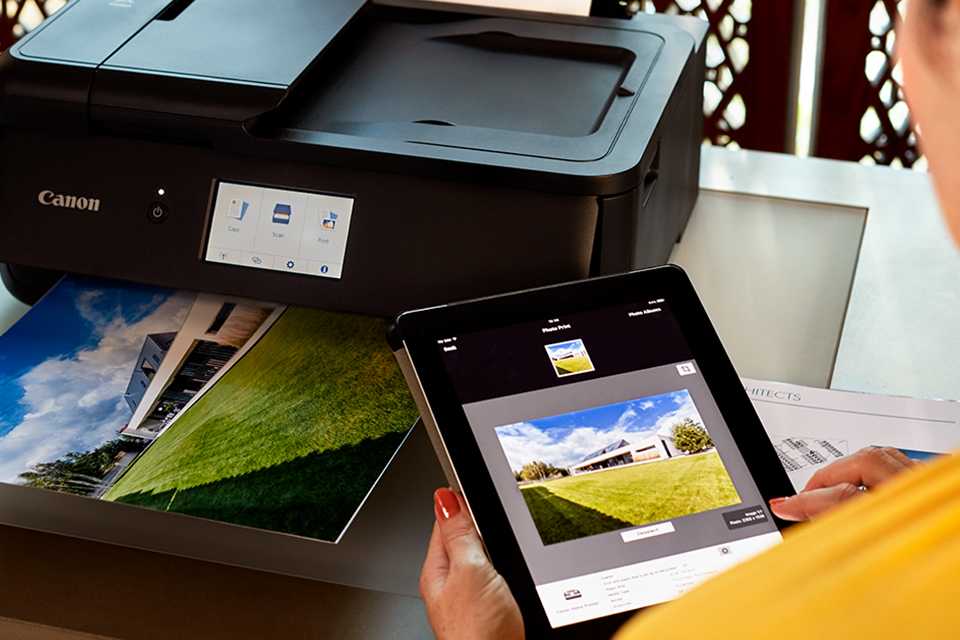 A person using Canon PRINT app to print a photograph from smart device.